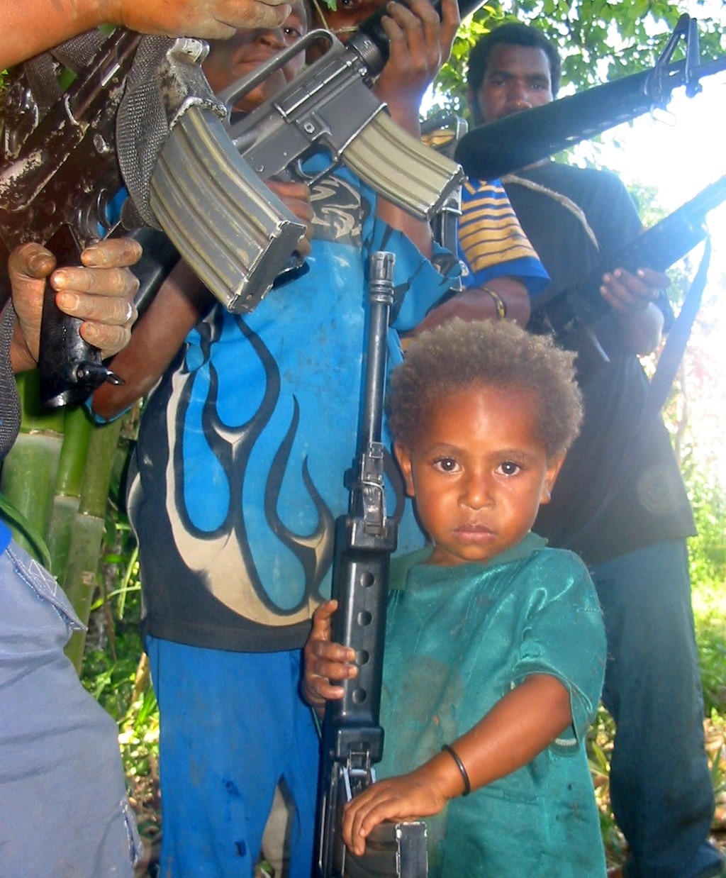 Nebilyer Valley tribal fighters and child with assault rifles