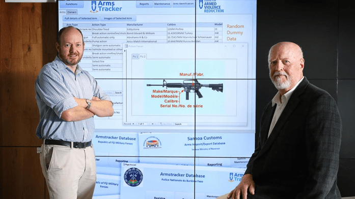 Alistair Gee and Philip Alpers with ArmsTracker video wall